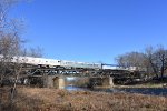 The former coaches and sleeper cars get their turn crossing the bridge